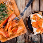 Toast with smoked salmon on wooden table